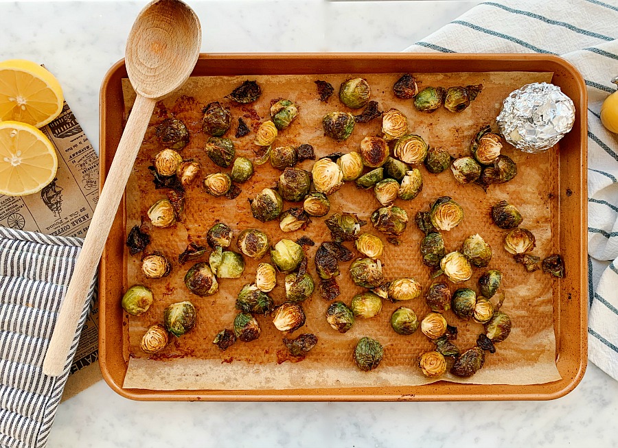 This sheet pan side dish is packed with flavor! A super easy and quick side dish for any meal! Roasted Brussels sprouts, crispy bacon and creamy roast garlic. And it's paleo!