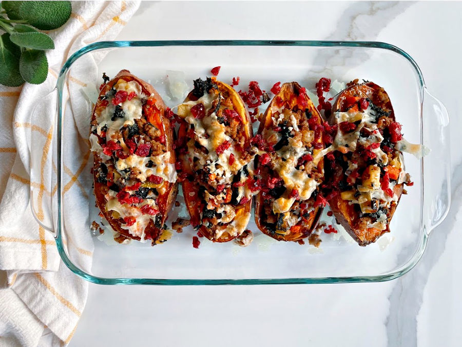 Simple, mouthwatering stuffed sweet potatoes! Savory sausage, kale, garlic and the bright pop of dried cranberries makes this a flavor packed weeknight meal! Paleo optional and gluten free!