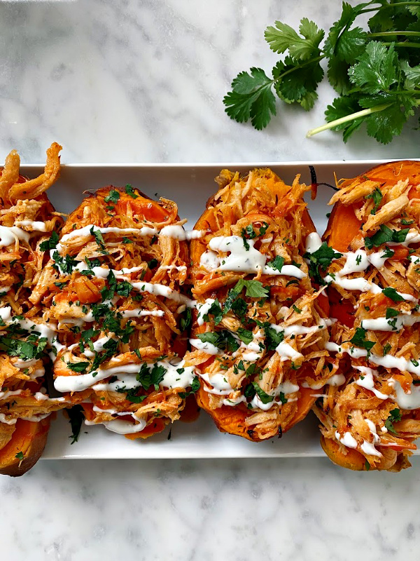 These stuffed sweet potatoes have juicy chicken tossed in a sweet and spicy sauce that is mouthwatering! 